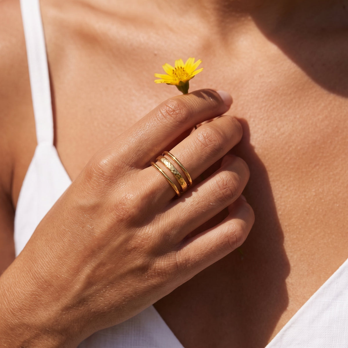 Wider view of a hand wearing the Triple Band Ring