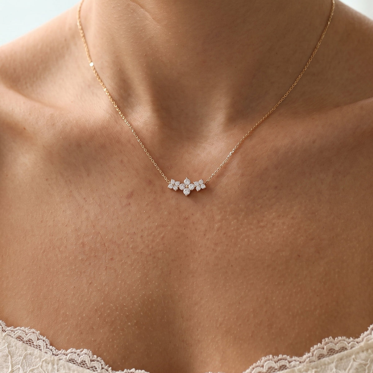 Close-up of the Triple Bloom Pendant worn on the neckline