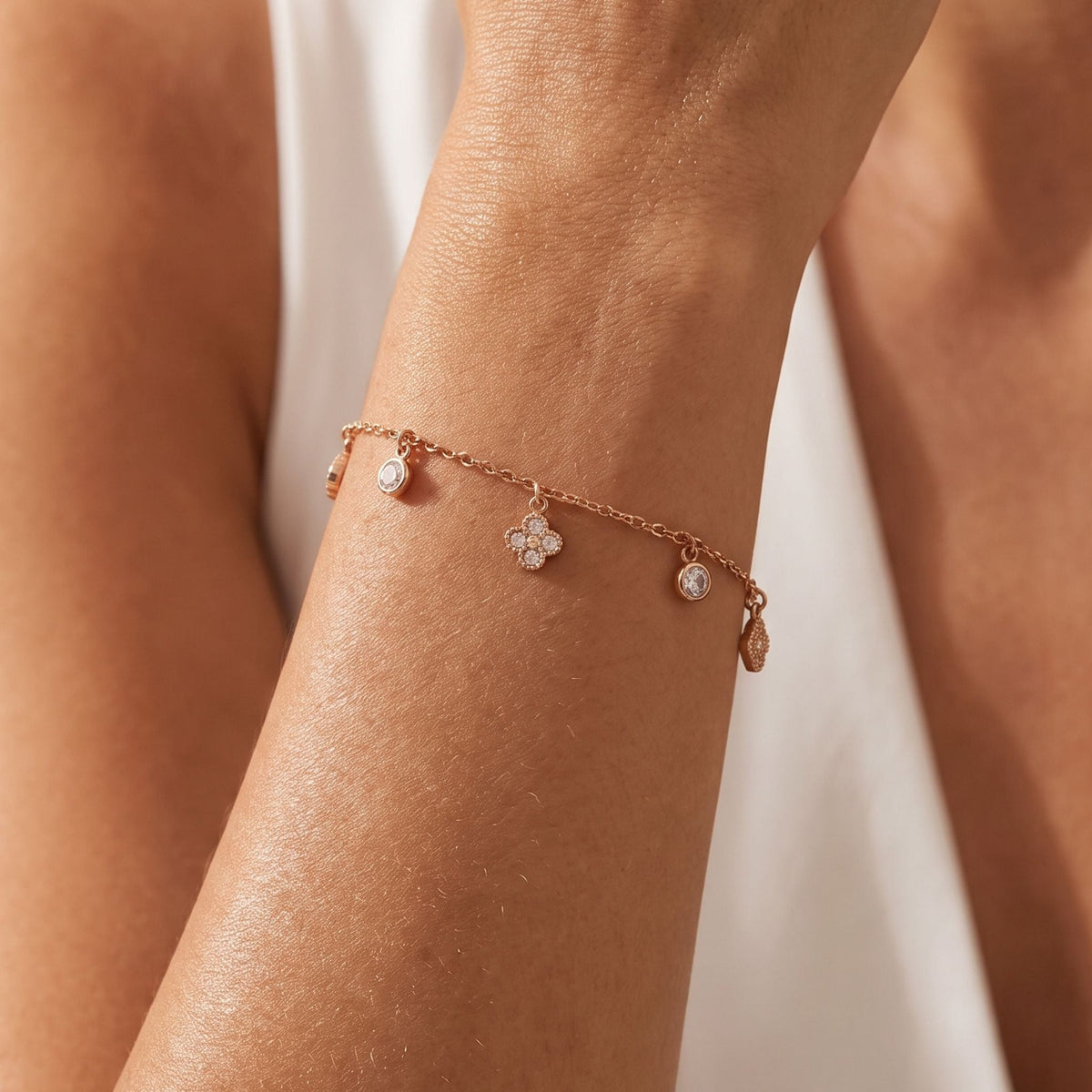 Whisper Clover Bracelet worn on the wrist, photographed in natural daylight.